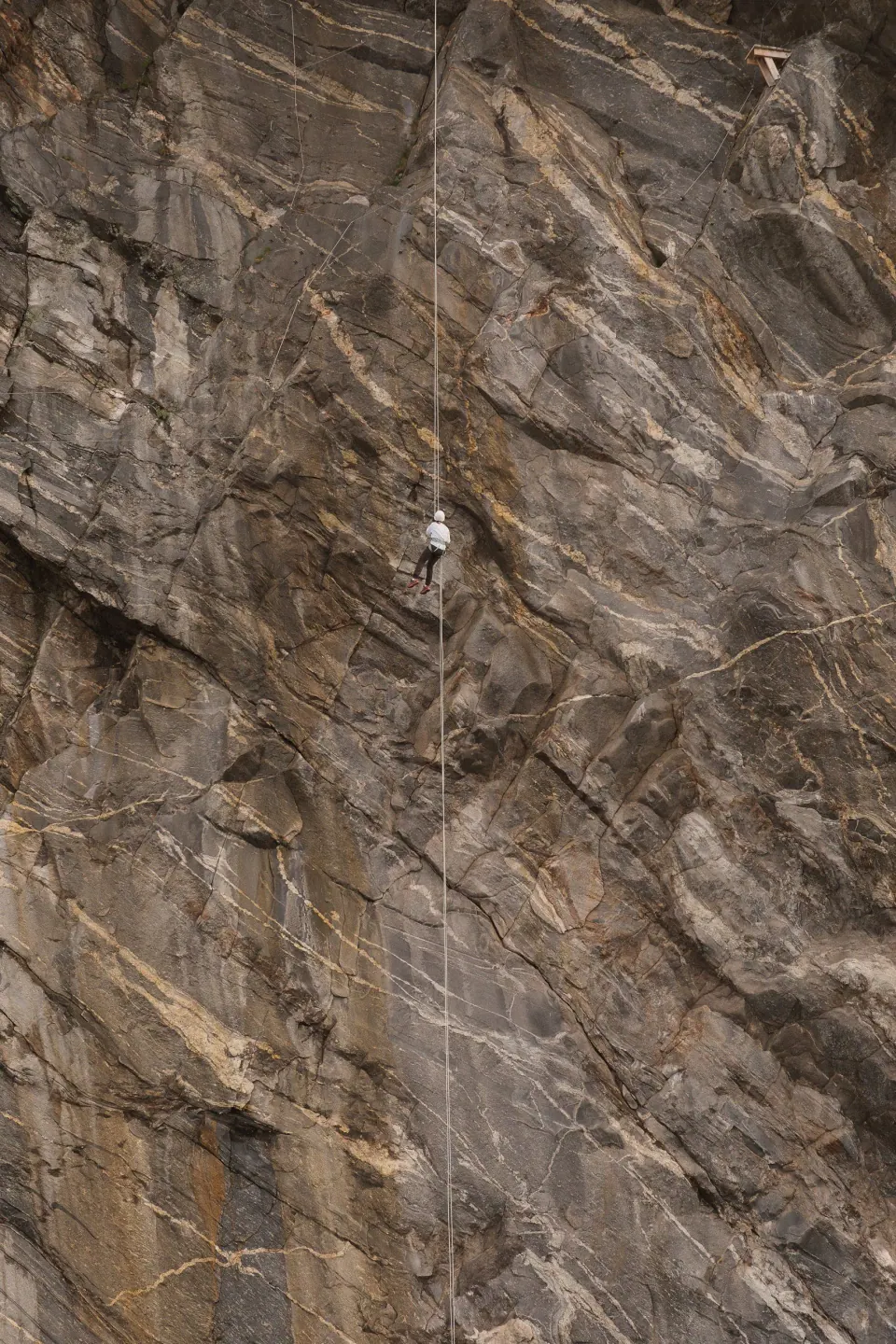 Guest rappelling down a coastal cliff at Bratten near Bodø, Nordland