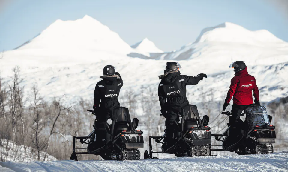 Electric snowmobile on the Arctic plateau at twilight near Bodø